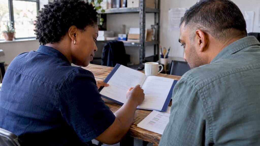 Diverse owners reviewing a workplace leave policy